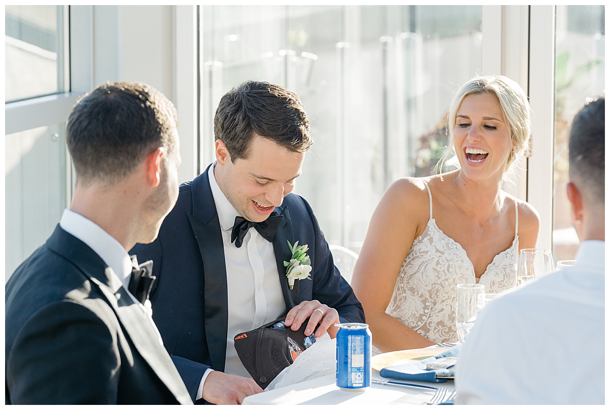 Bride and Groom laughing at Revery reception in Columbus, Ohio photographed by Ashleigh Grzybowski an Ohio wedding photographer