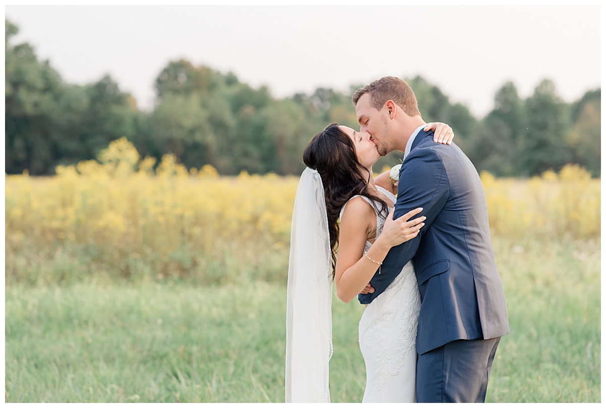 Bride and groom kissing in Columbus, Ohio at Brookshire event venue taken by Ohio Wedding Photographer Ashleigh Grzybowski