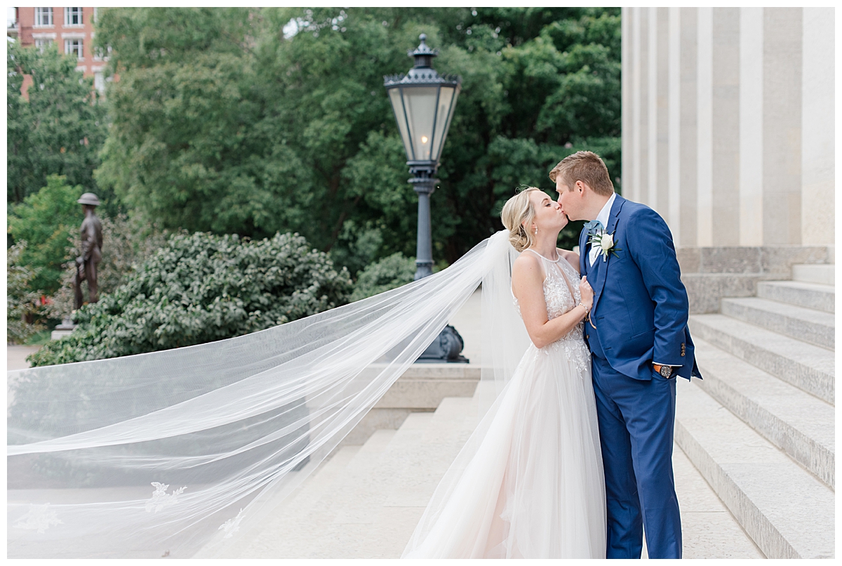 Bride and Groom kissing on steps of Ohio State House at wedding in Columbus, Ohio taken by Ashleigh grzybowski
