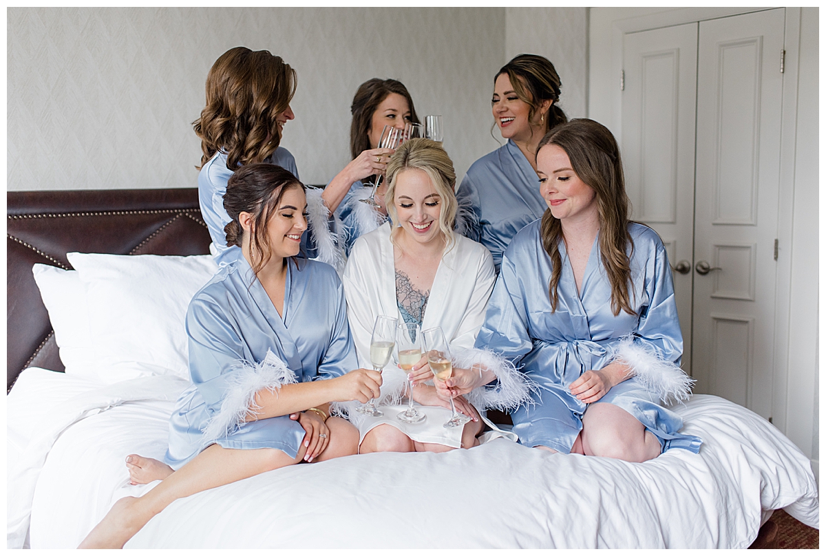 Bridesmaids drinking champagne at Athletic Club of Columbus in bridal suite photographed by Ohio wedding photographer Ashleigh Grzybowski