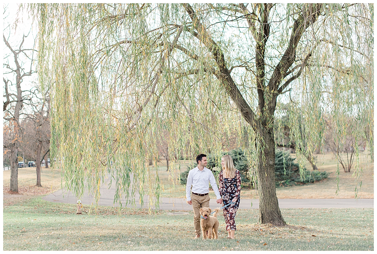 Couple by tree at Columbus, Ohio engagement session in Franklin Park taken by Columbus Ohio Wedding Photographer Ashleigh Grzybowski