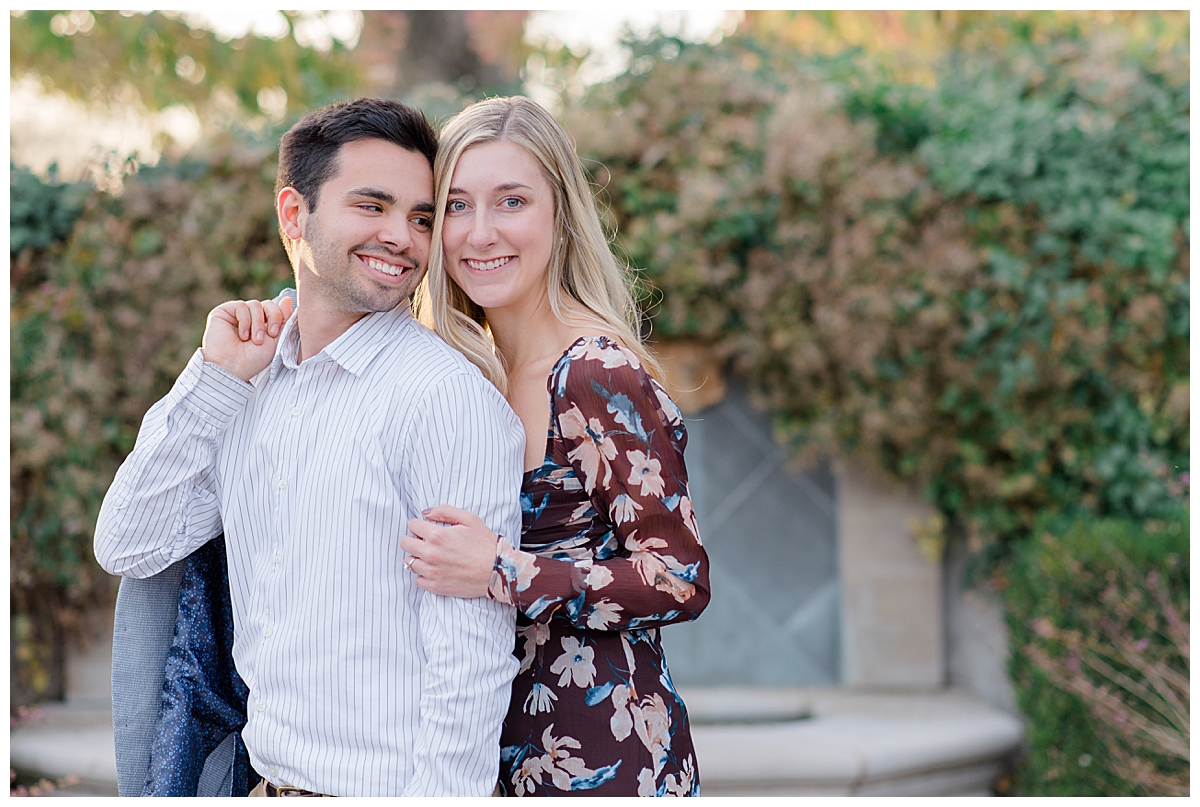 Couple smiling at each other at Columbus, Ohio engagement session in Franklin Park taken by Ohio Wedding Photographer Ashleigh Grzybowski