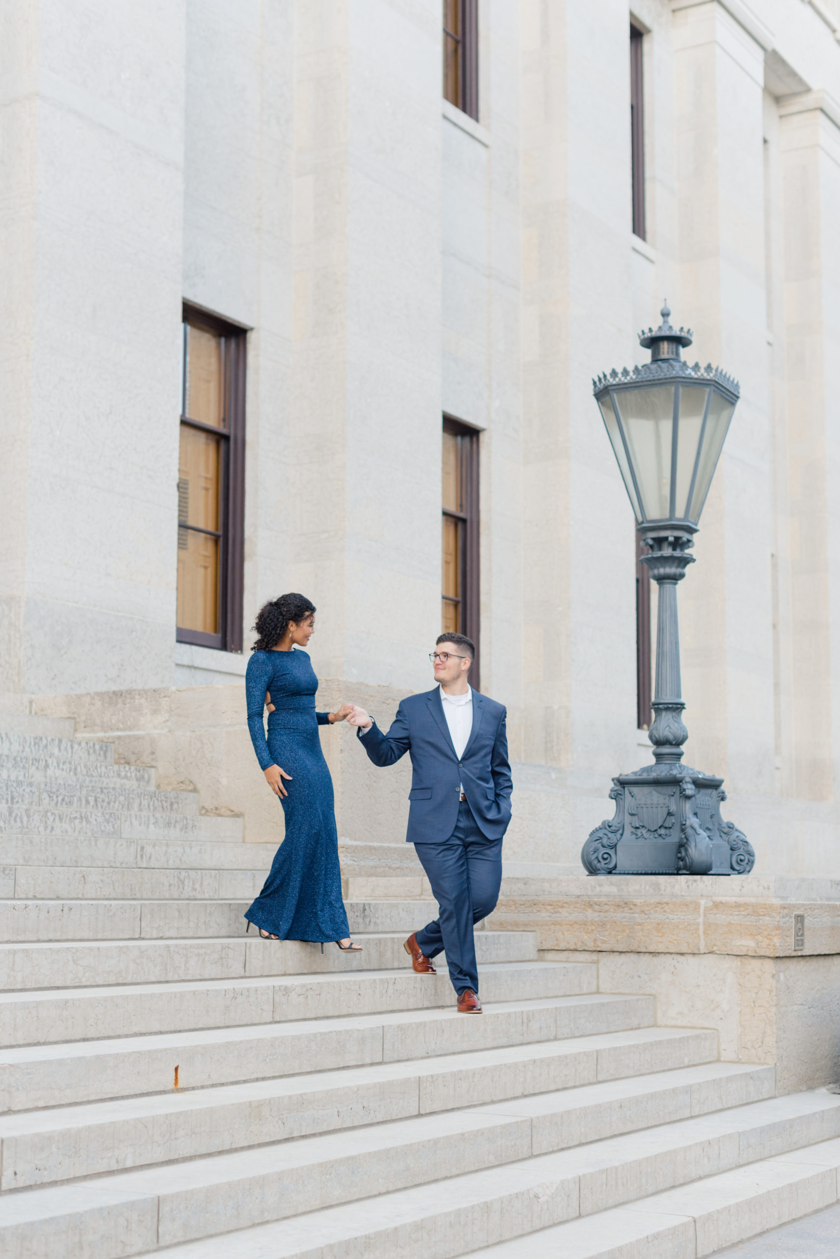 Couple walking down the steps at Ohio State House engagement session in Columbus, Ohio taken by Ohio Wedding Photographer Ashleigh Grzybowski