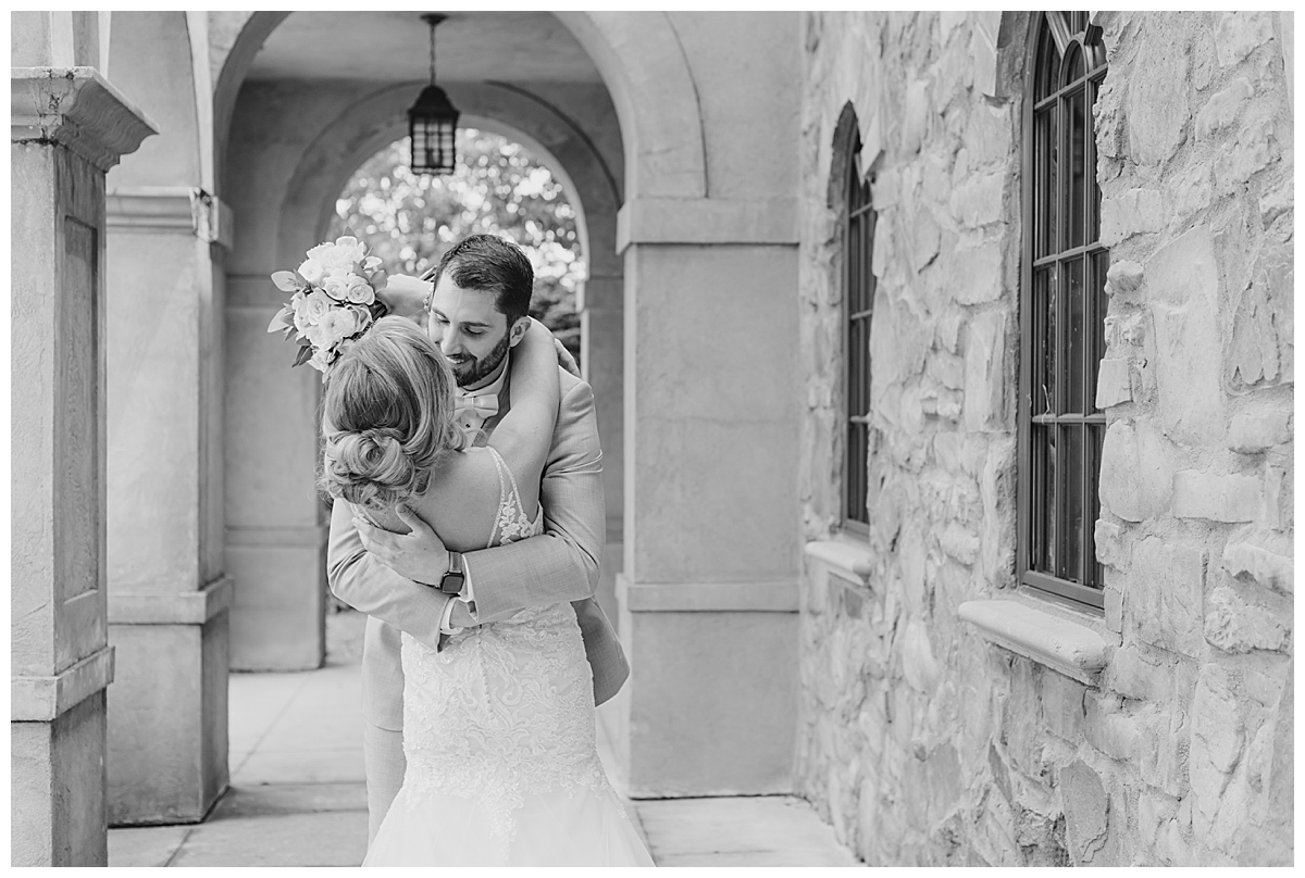 Groom kissing bride during first look at Club of Corazon in Columbus Ohio taken by Ohio Wedding Photographer Ashleigh Grzybowski