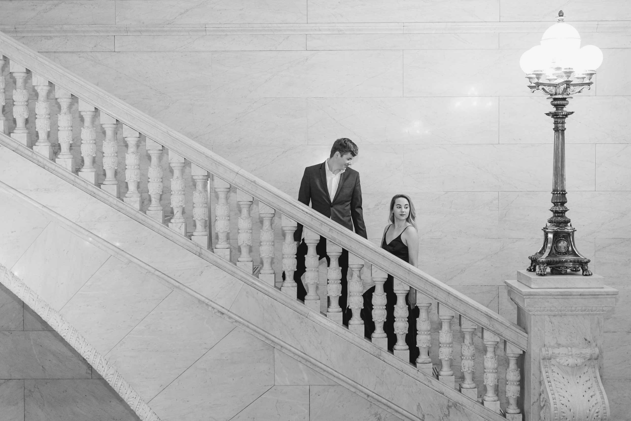 Couple on stairs at Ohio State House engagement session in Columbus, Ohio taken by Ohio wedding photographer Ashleigh Grzybowski
