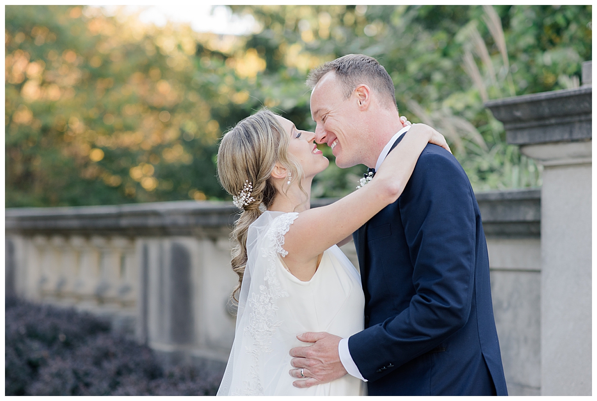 Bride and groom kissing at Scioto Mile for wedding at The Fives in Columbus, Ohio taken by Ohio Wedding photographer Ashleigh Grzybowski