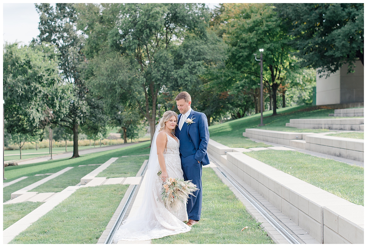 Groom and Bride smiling at Scioto Mile in Columbus, Ohio taken by Ashleigh Grzybowski an Ohio Wedding Photographer  for a wedding at The Vue