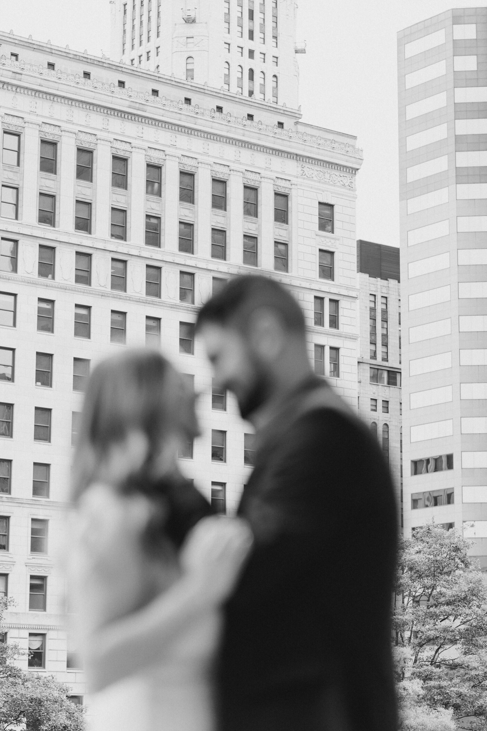 black and white engagement photos in Columbus Ohio downtown with couple embracing
