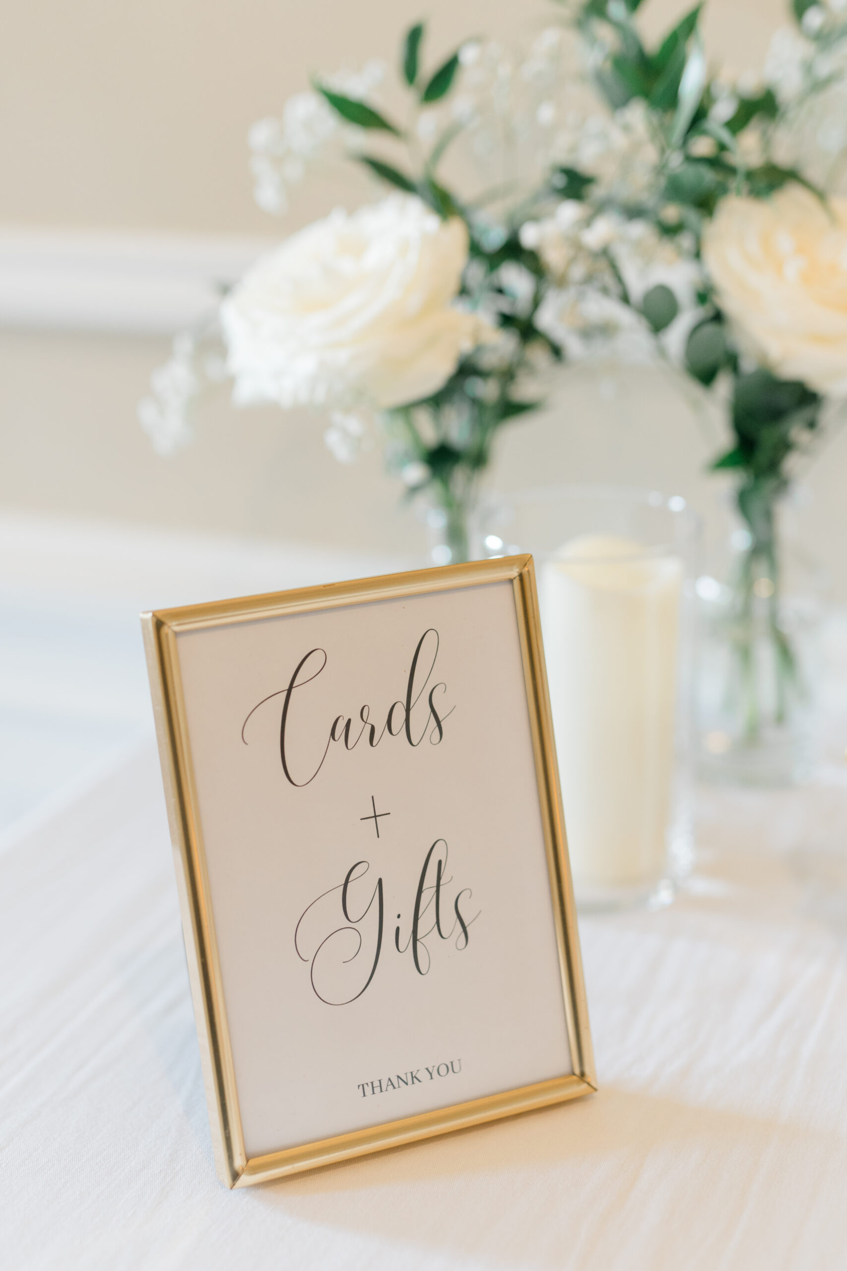 detail shot of "gifts and cards" signage on a gift table at wedding reception