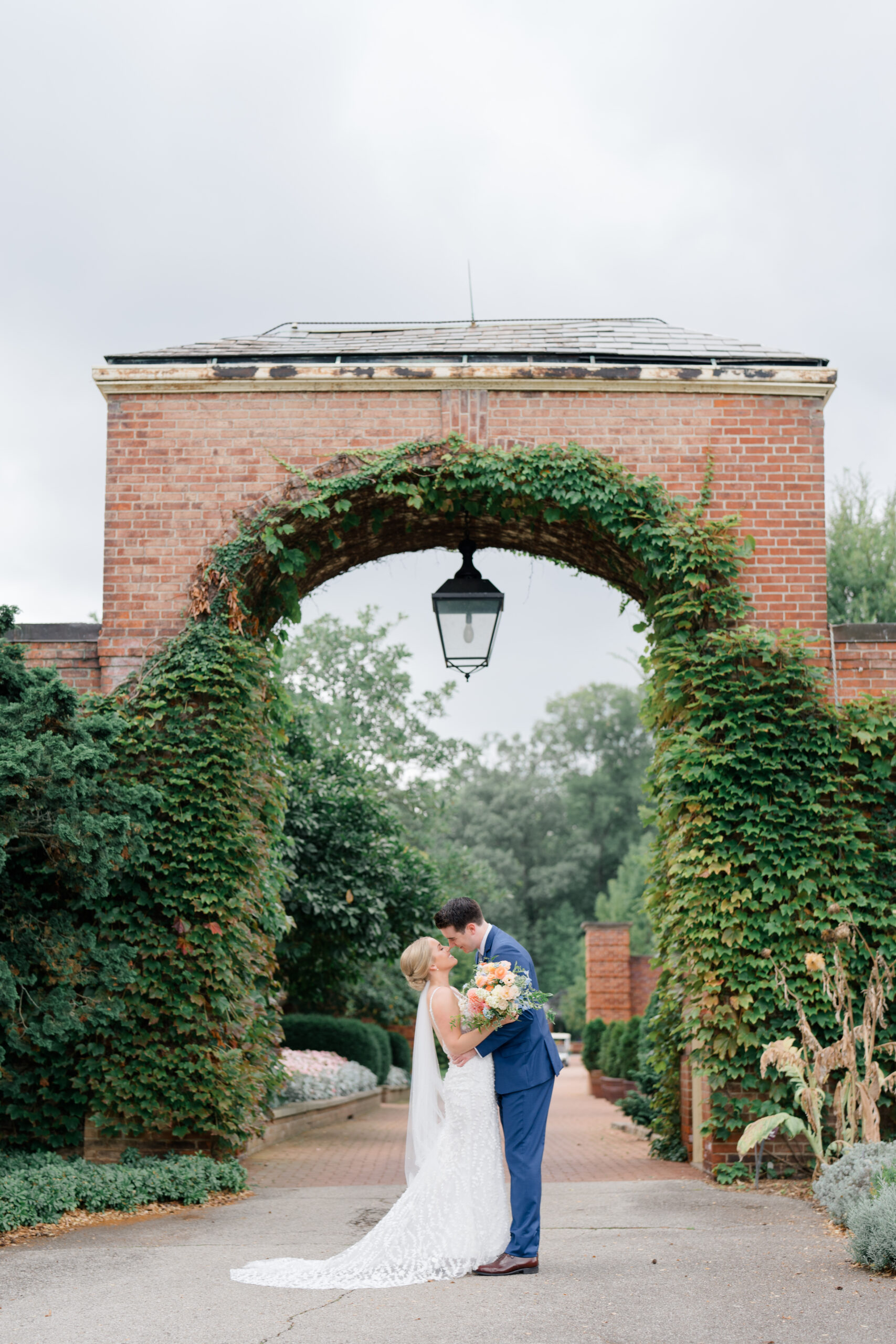 groom dips her backwards and kisses her passionately at Kingwood Gardens wedding